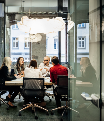 Employees around a table in collaboration